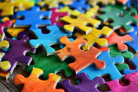 pieces of a jigsaw puzzle in various colors in a random pile